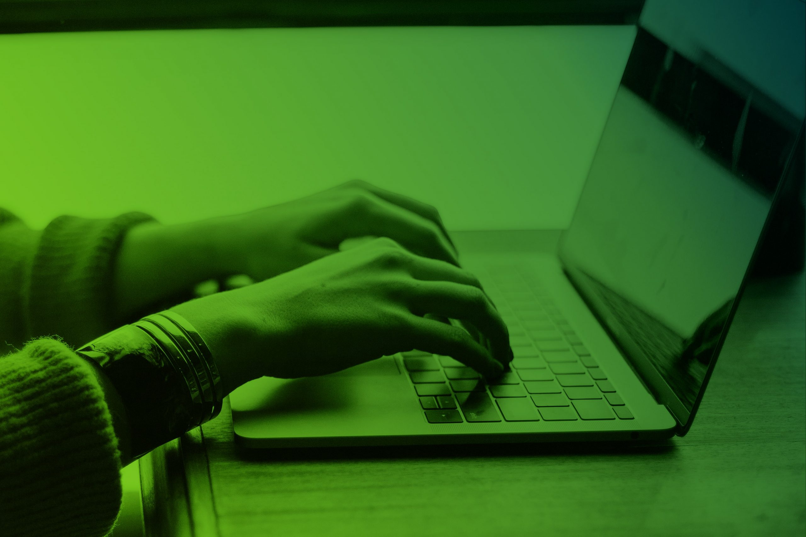 Female hands typing at a laptop keyboard